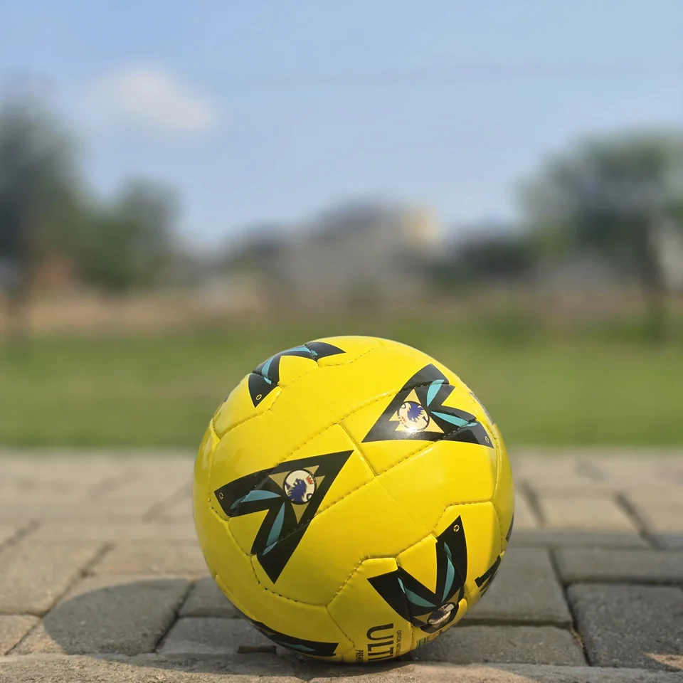 Yellow Black Graphic Hand-Stitched Football side view - bright yellow handmade football with black angular graphic panels