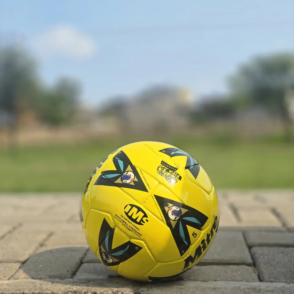 Yellow Black Graphic Hand-Stitched Football side view - bright yellow handmade football with black angular graphic panels