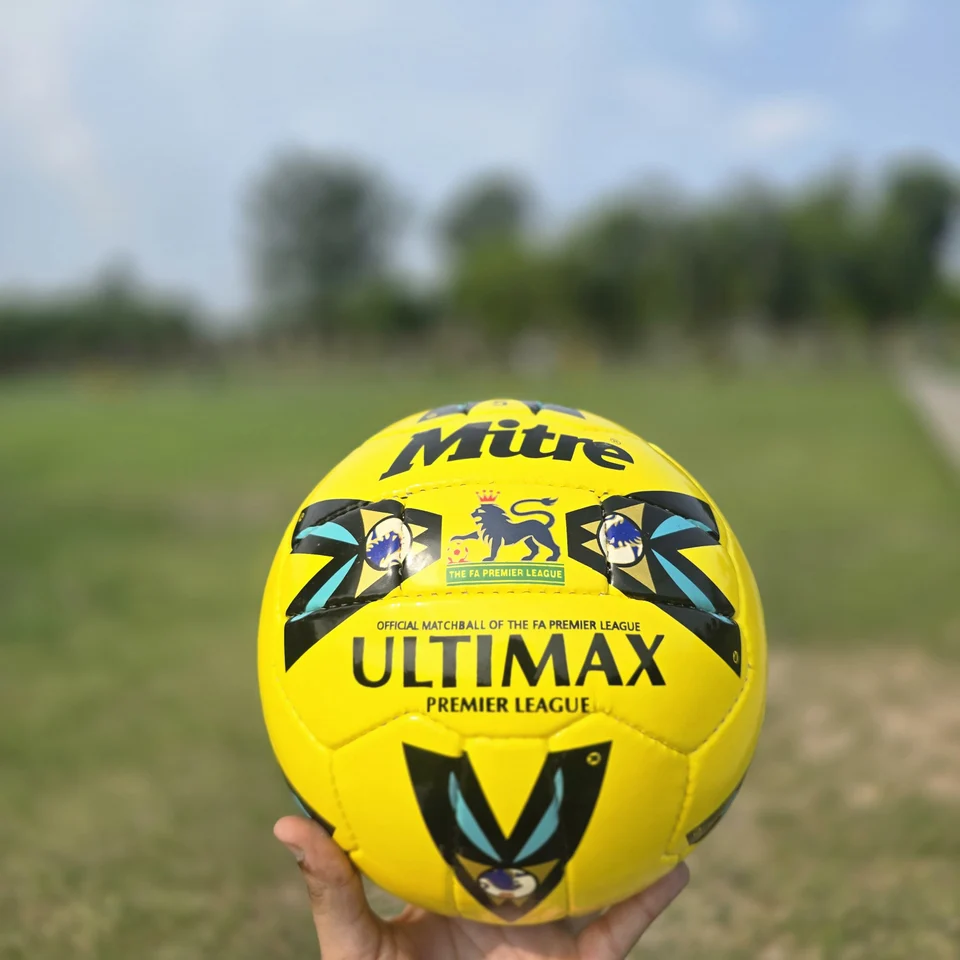 Yellow Premier-Style Printed Hand-Stitched Football front view - yellow handmade football with black graphic panels and visible printed match-ball style text