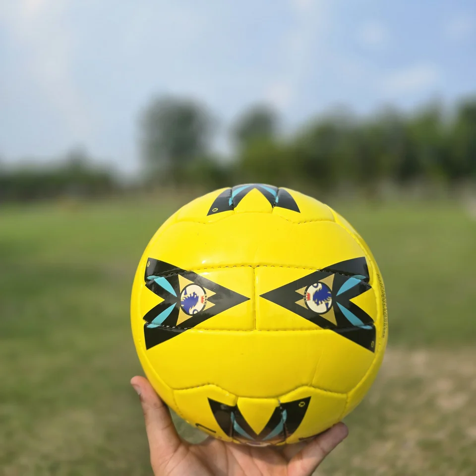 Yellow Premier-Style Printed Hand-Stitched Football side view - yellow handmade football with black graphic panels and visible printed match-ball style text