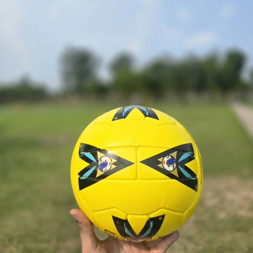 Yellow Premier-Style Printed Hand-Stitched Football side view - yellow handmade football with black graphic panels and visible printed match-ball style text