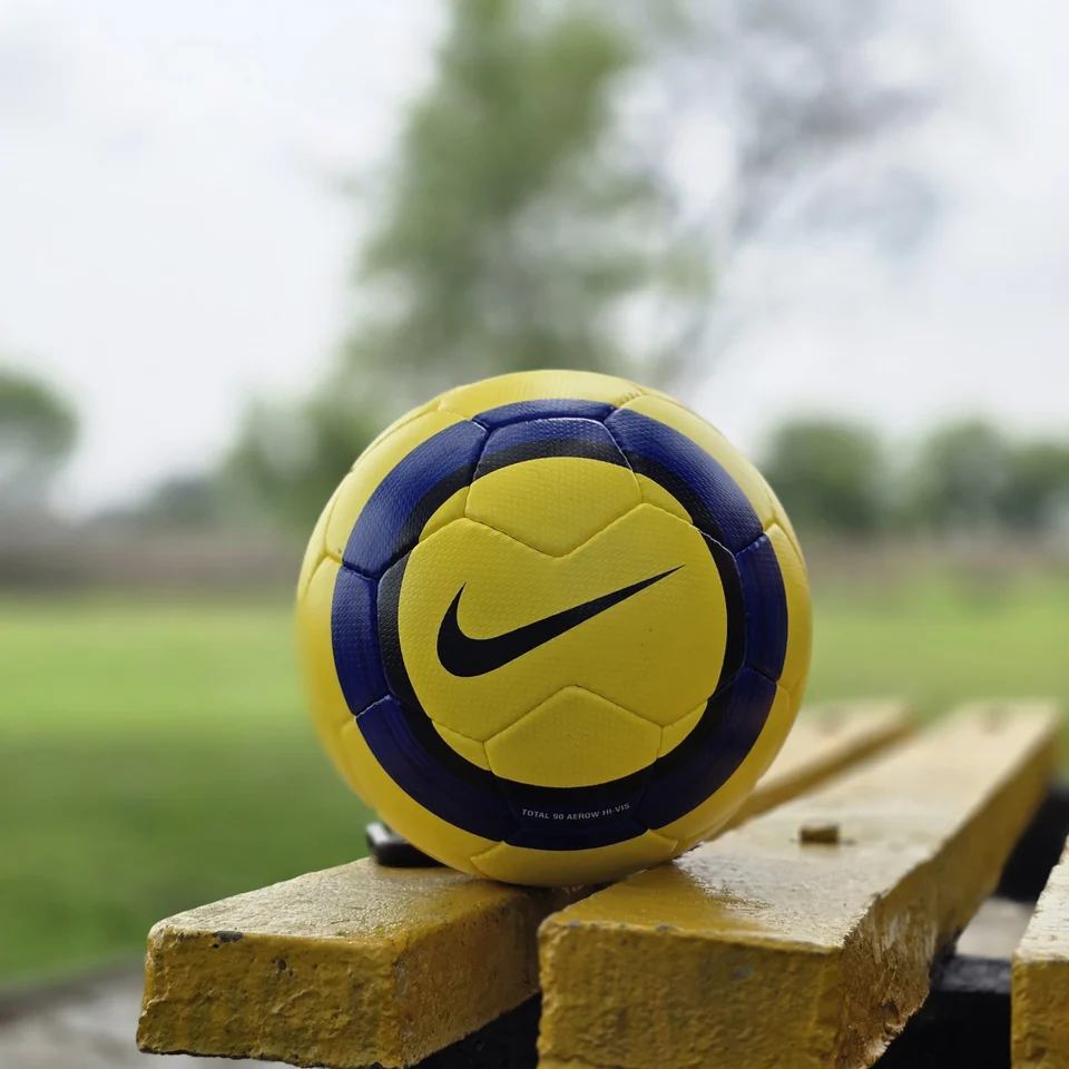 Yellow Ultimax-Style Printed Hand-Stitched Football back view - yellow handmade football with black angular graphics and visible Ultimax-style printed text